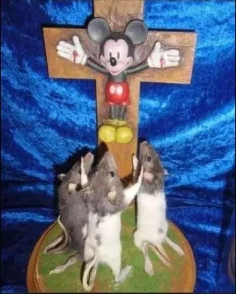 mickey on a jesus cross with live rats reaching up for it