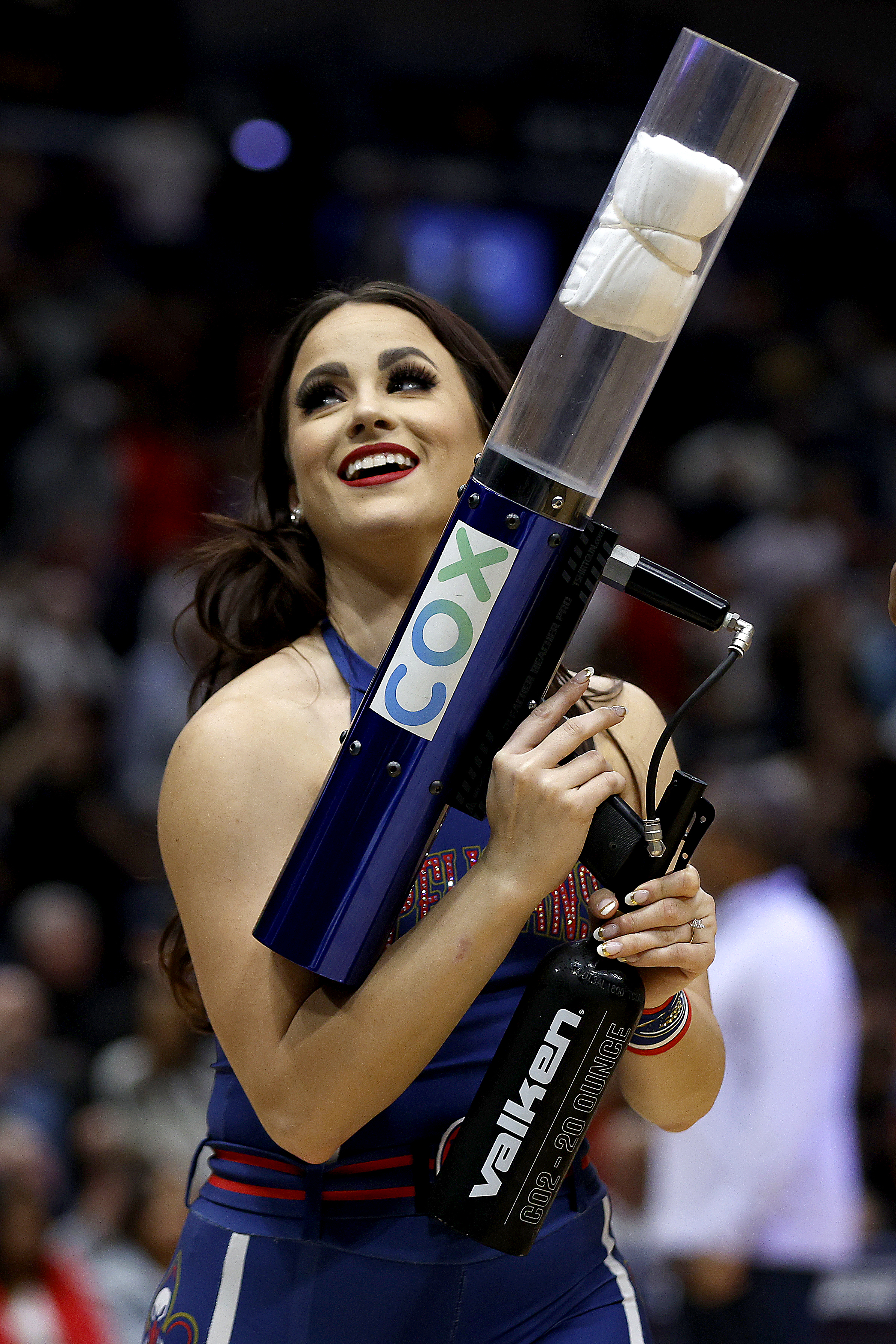 A woman holding a T-shirt cannon