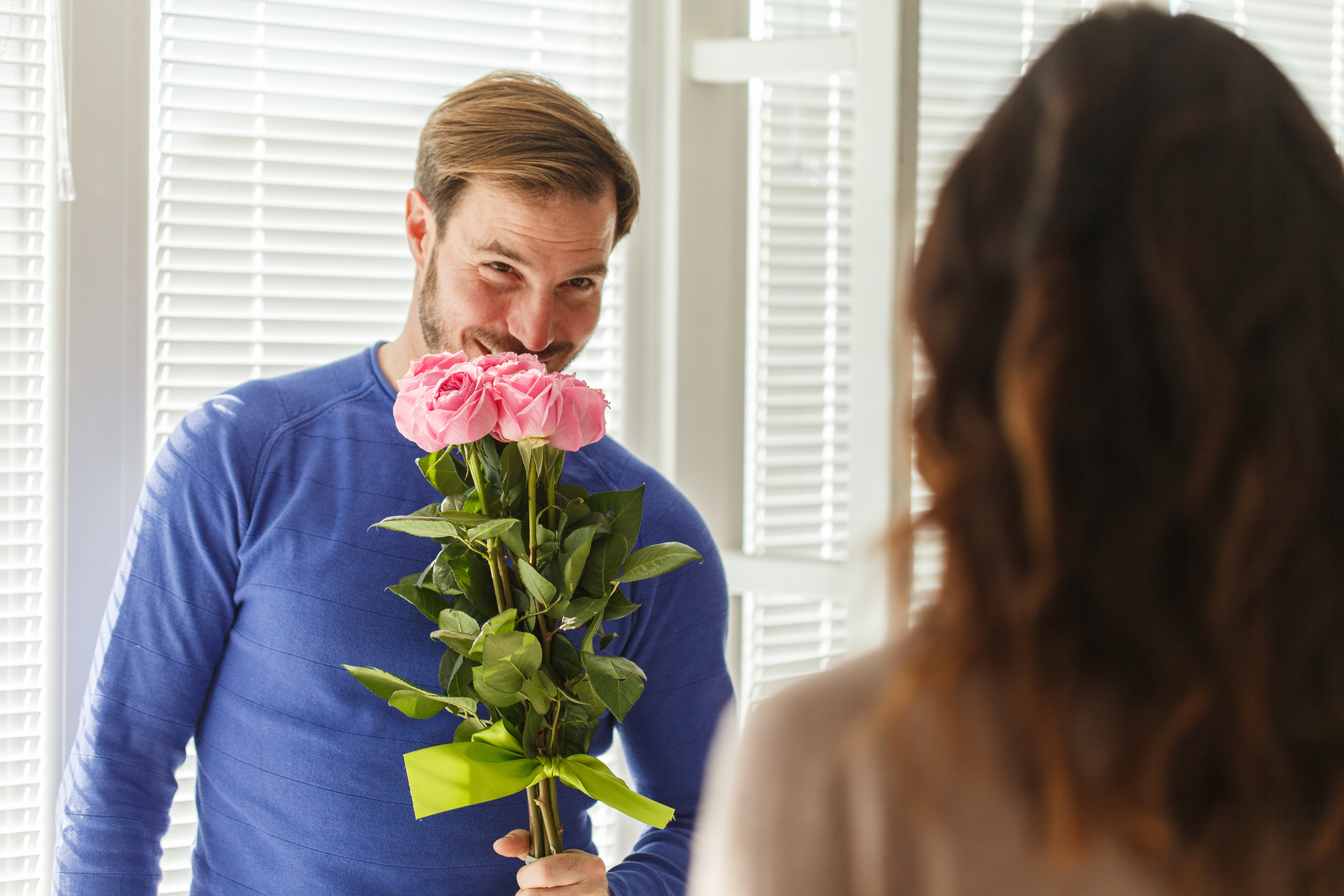 guy holding out flowers for someone