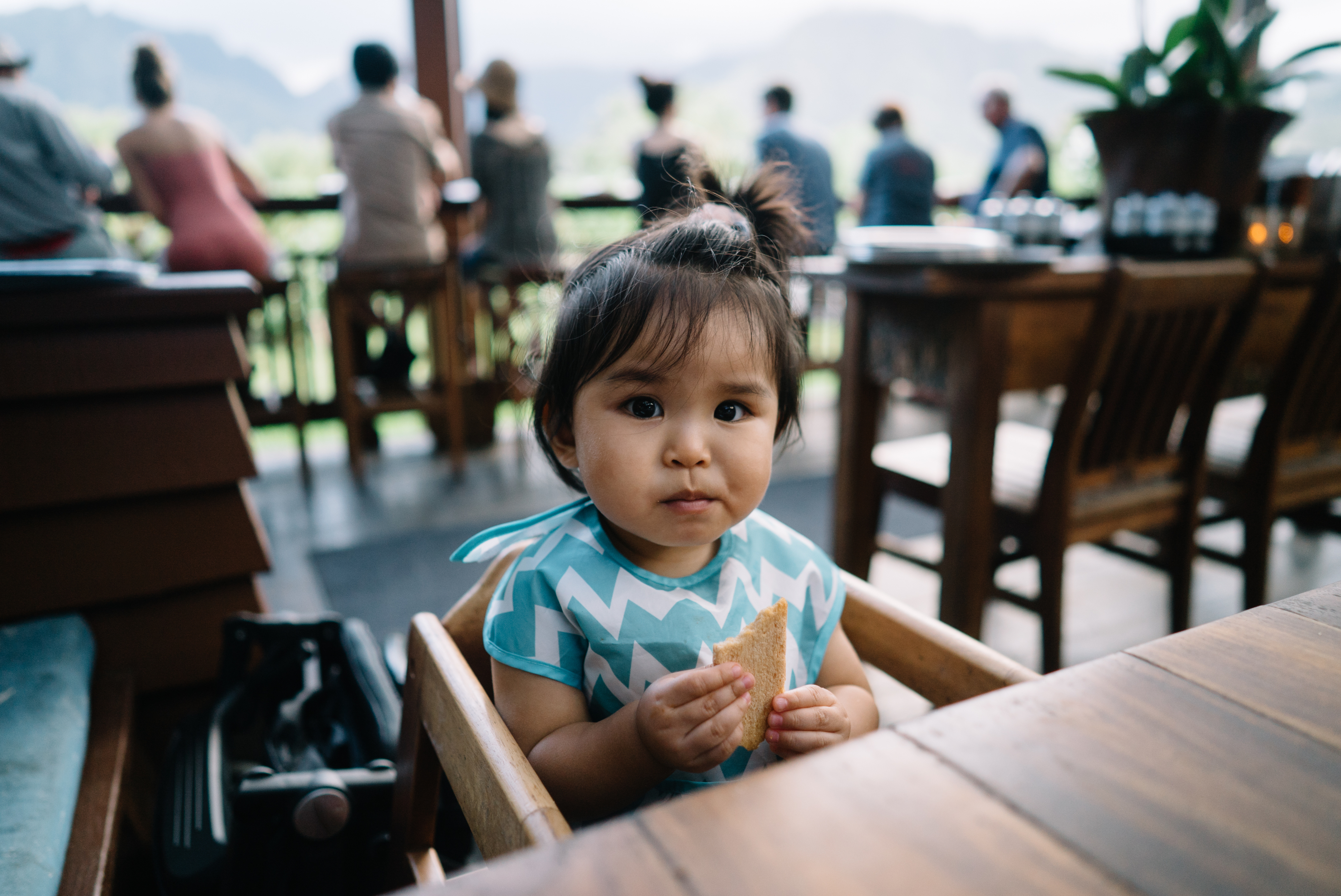 a baby in a high chair in a restaurant