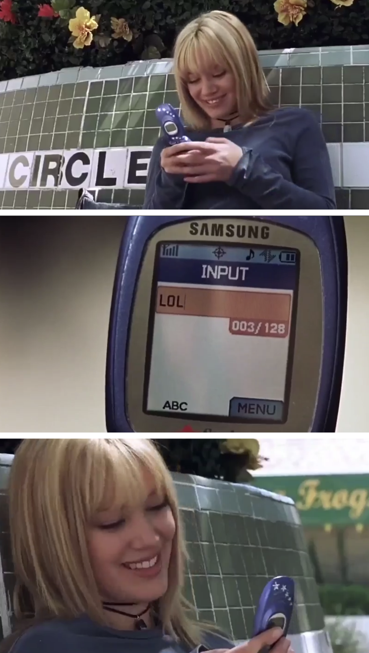 someone writing lol as a text message on a flip phone