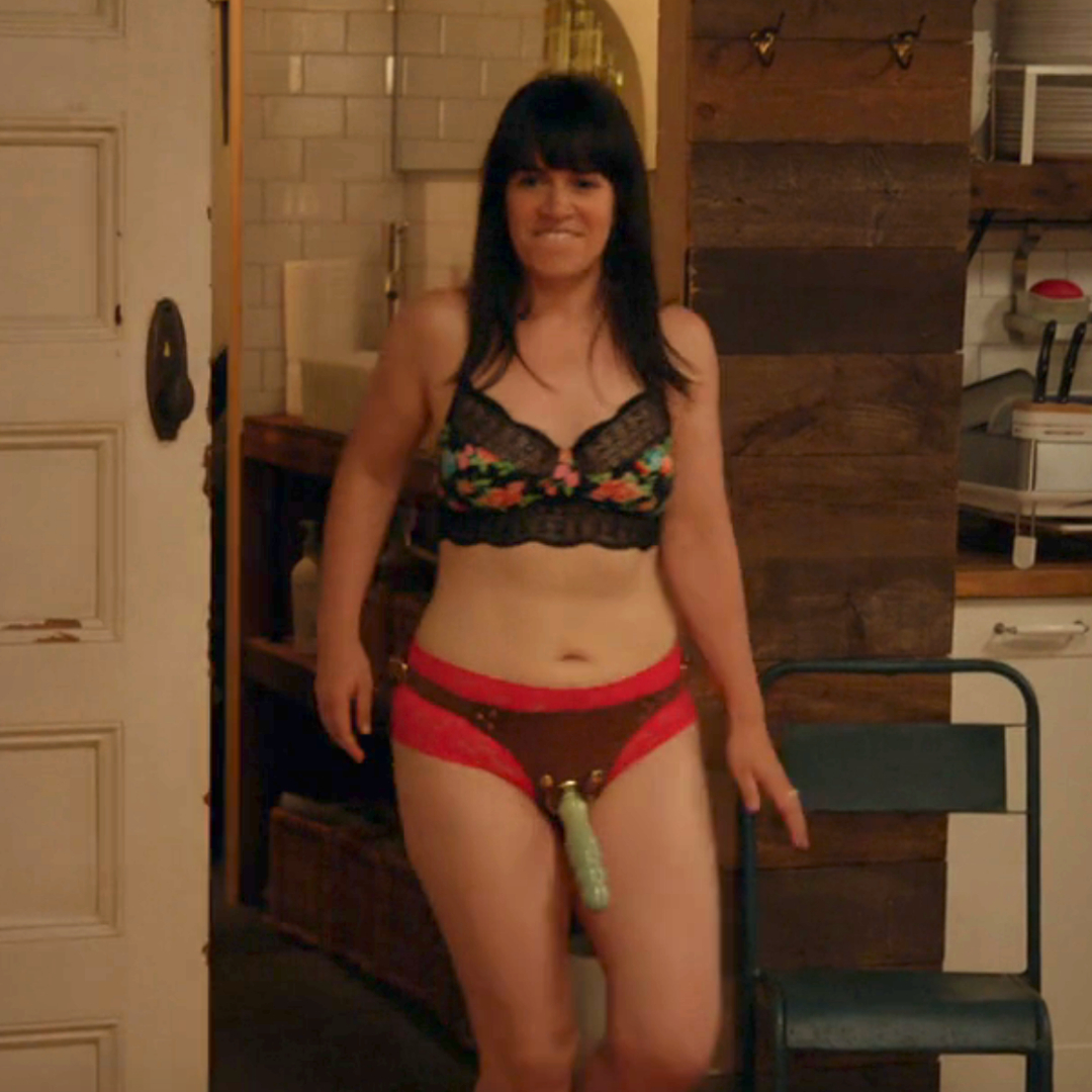 Abbi from "Broad City" walking out with a strap on