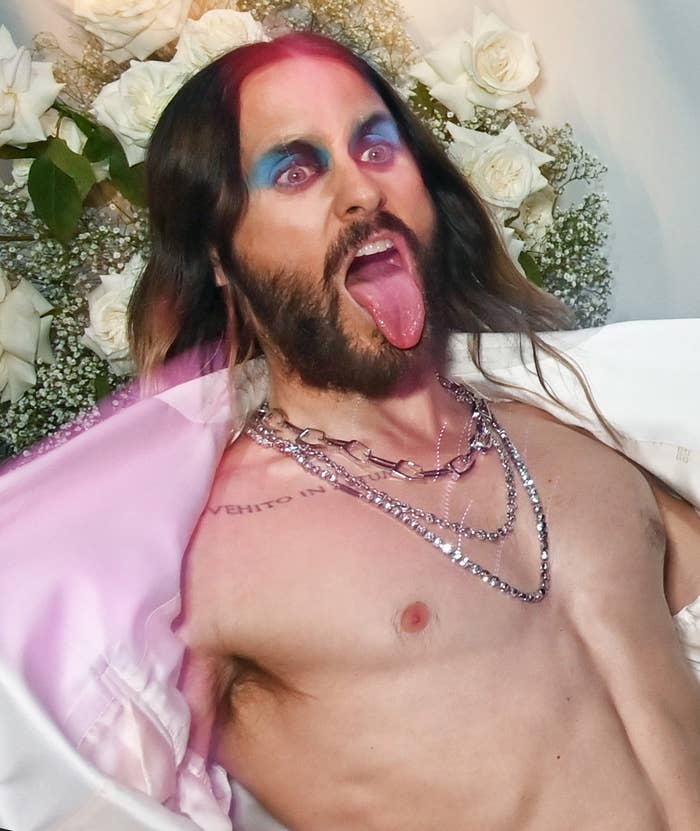 jared leto sticking out his tongue and opening his blazer to show his chest