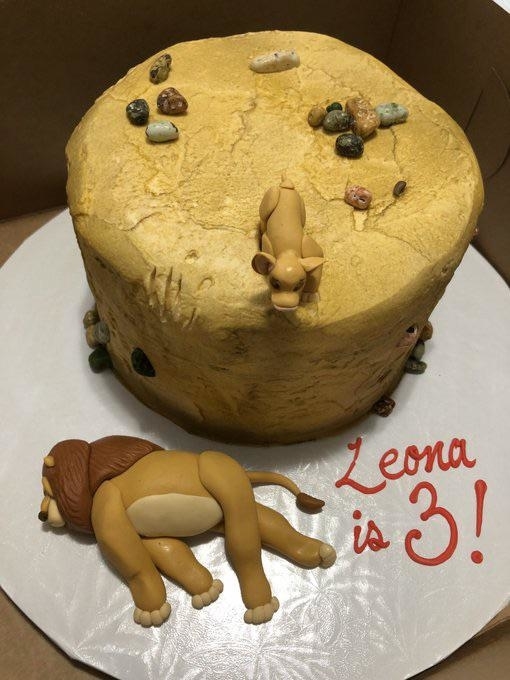 a lion king themed cake with simba&#x27;s dad pushed off the cliff