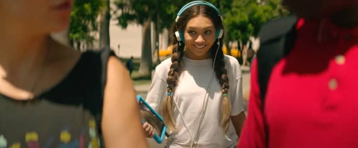 closeup of maddie in the movie walking with headphones on and a tablet in hand