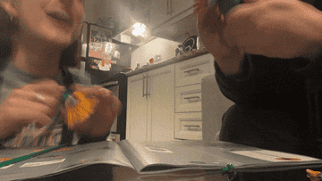 gif of two people building lego