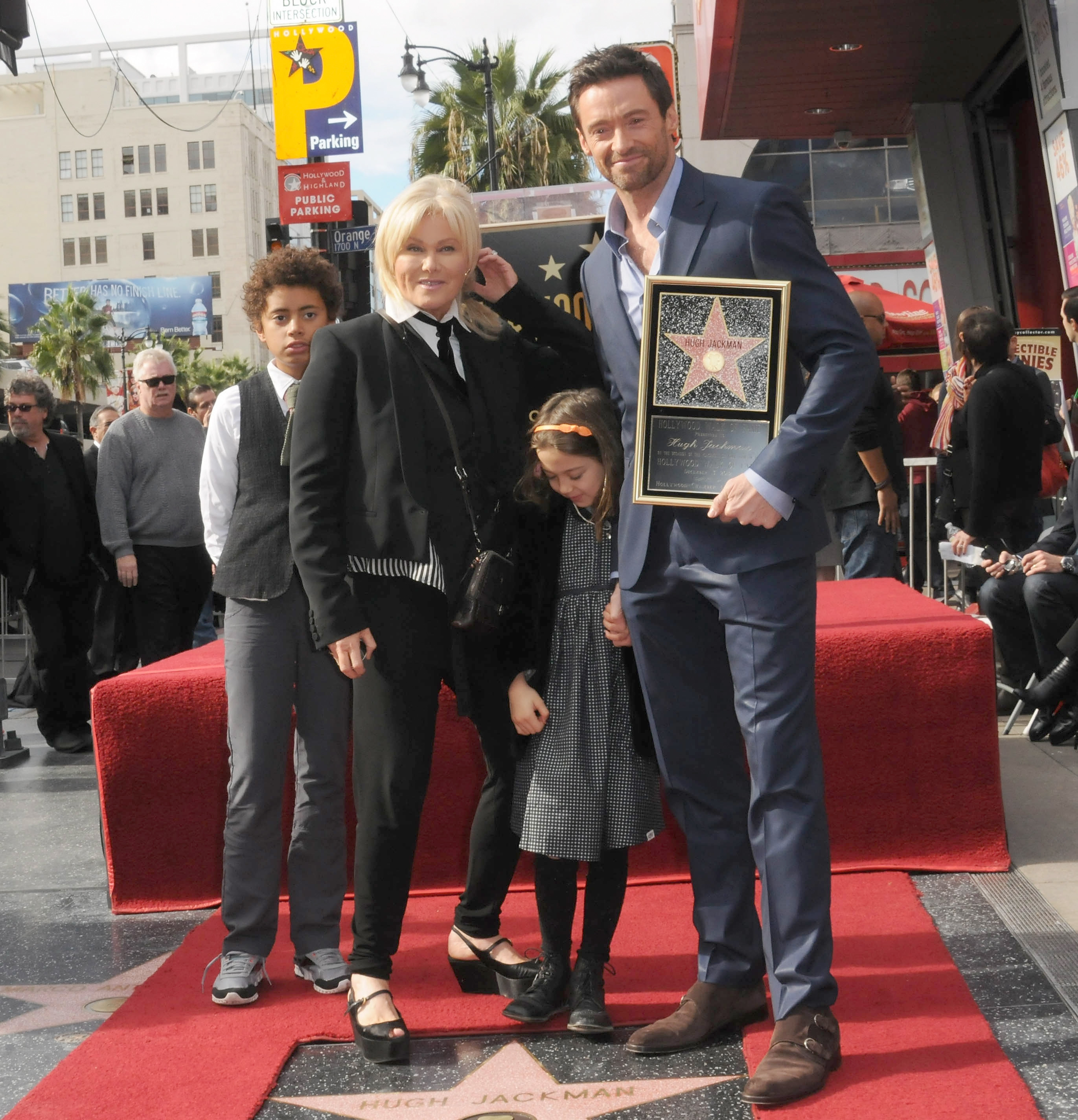 Hugh Jackman and Deborra-Lee Furness with their children on the Hollywood Walk of Fame with Hugh holding his plaque