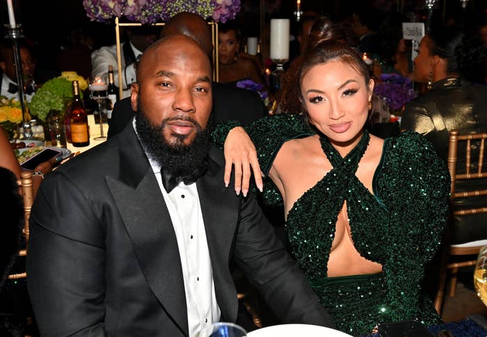 Jeezy and The Real cohost Jeannie Mai sitting at a dinner table for an event pose for a photo