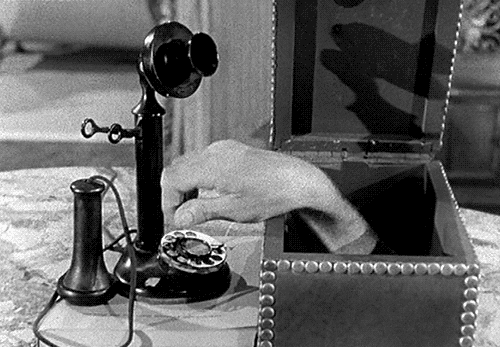 hand in a box dialing a phone