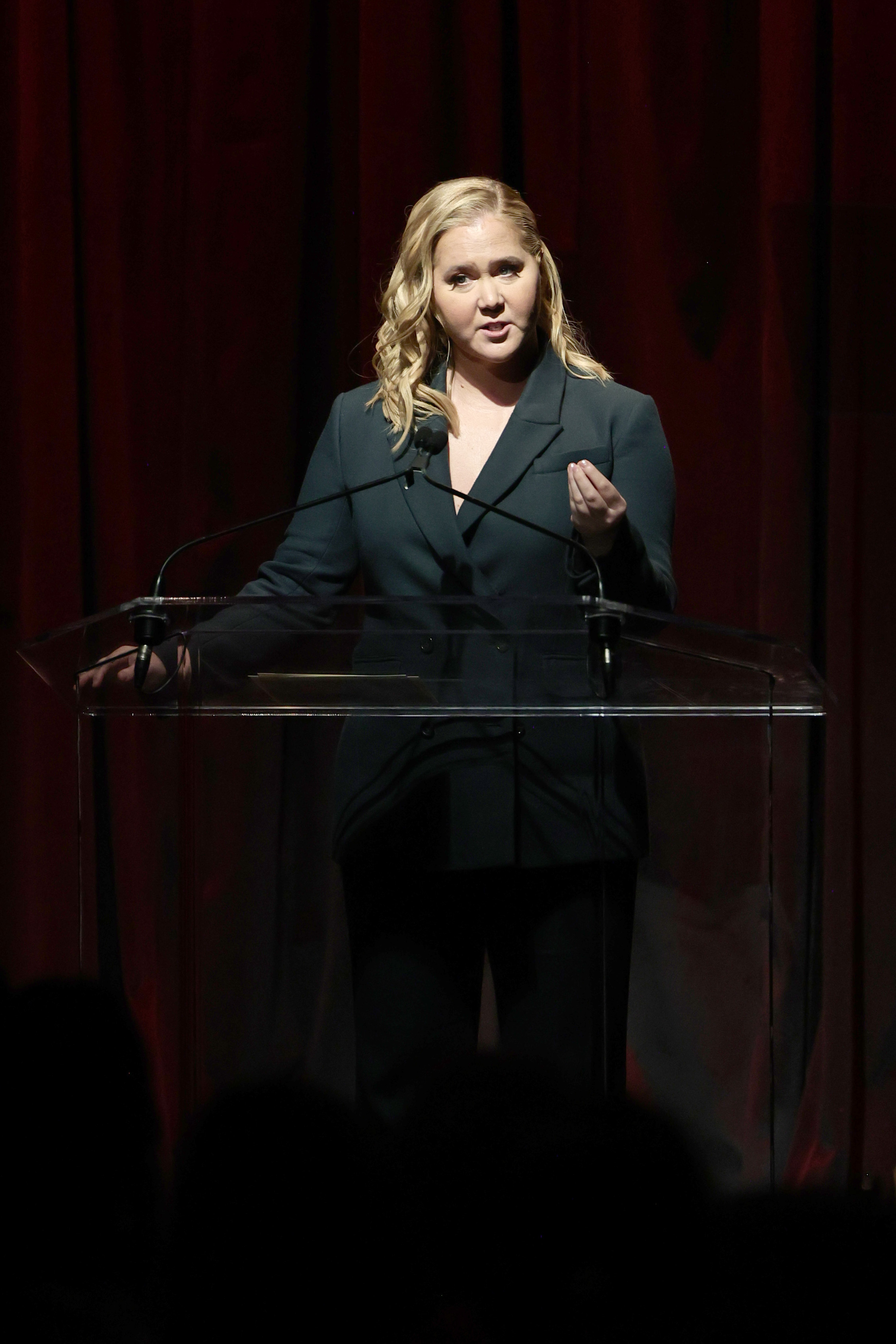 amy speaking at a podium