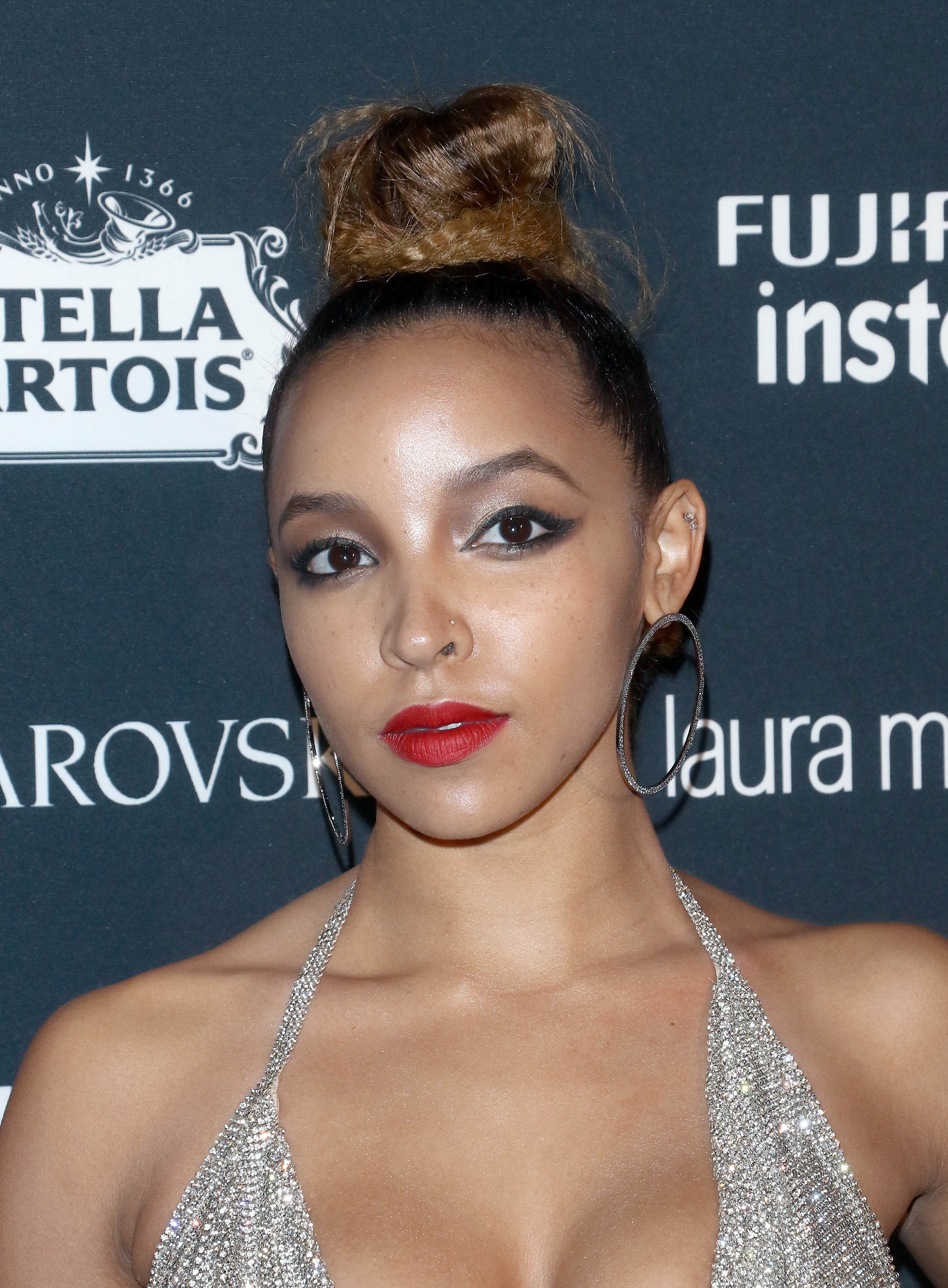 Close-up of Tinashe at a media event in a bejeweled halter top