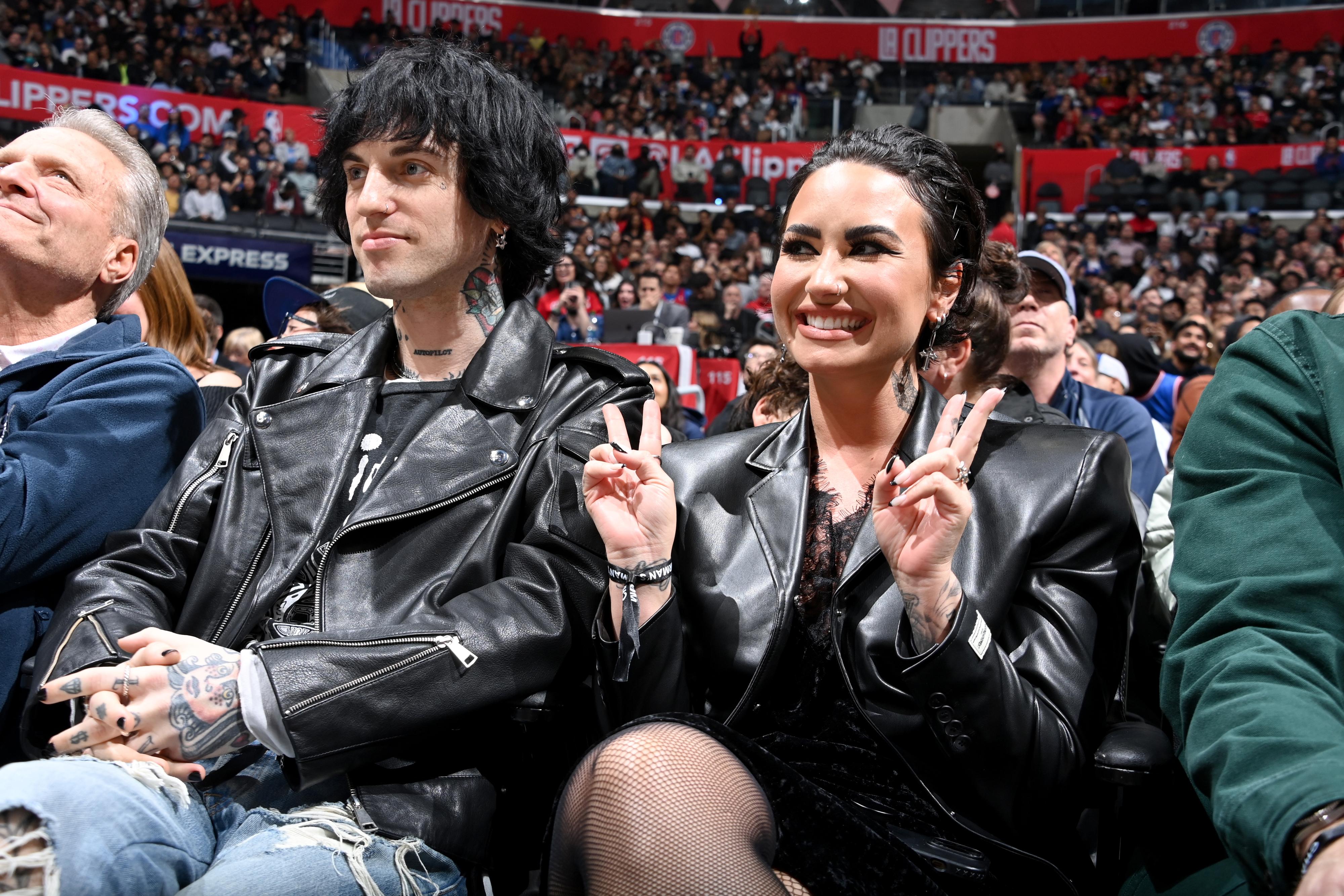 Jutes and Demi sitting in a stadium together
