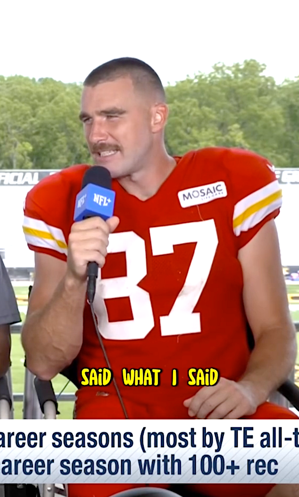 Close-up of Travis talking into a microphone