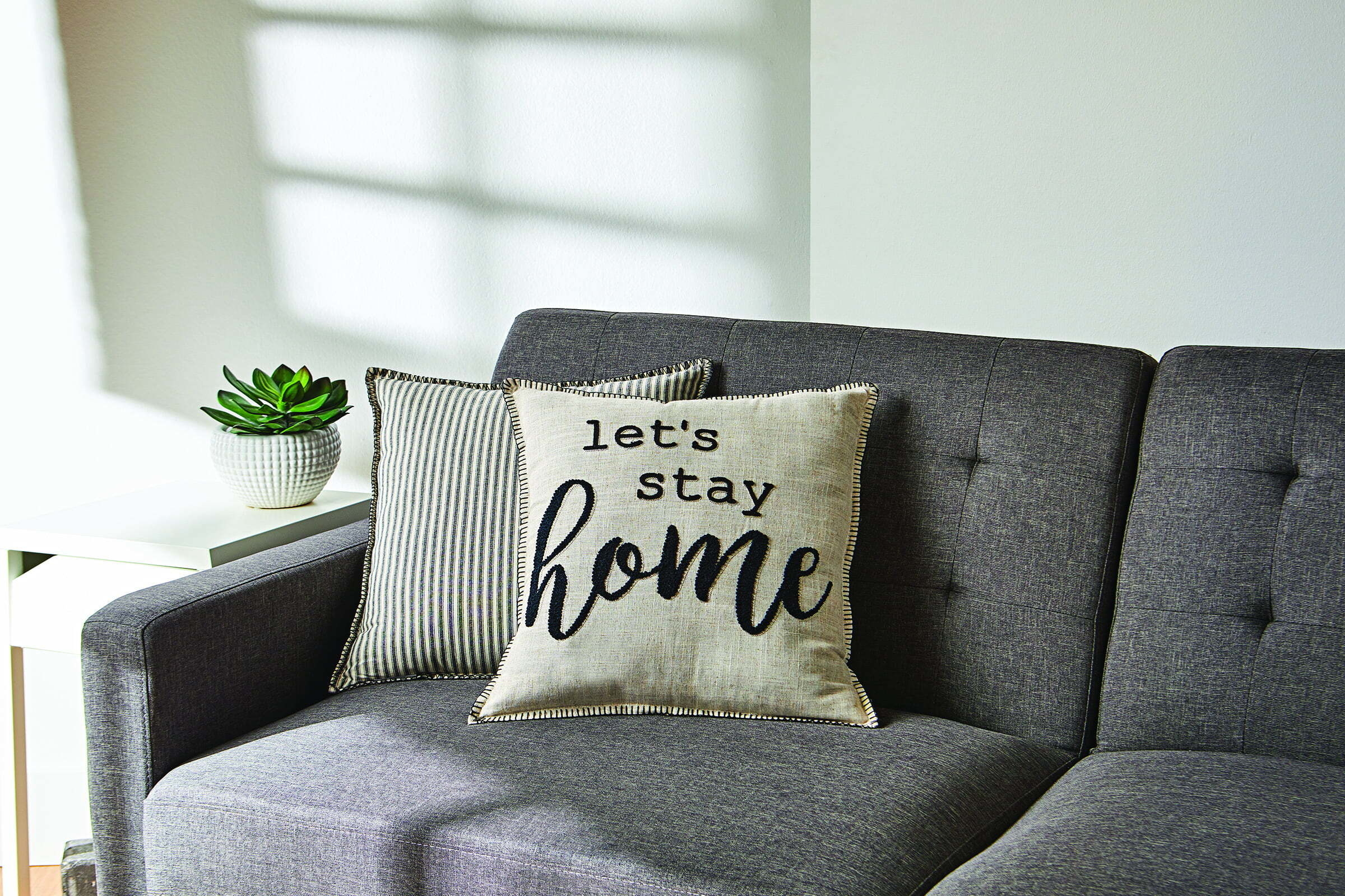 The pillow, which reads &quot;let&#x27;s stay home&quot;