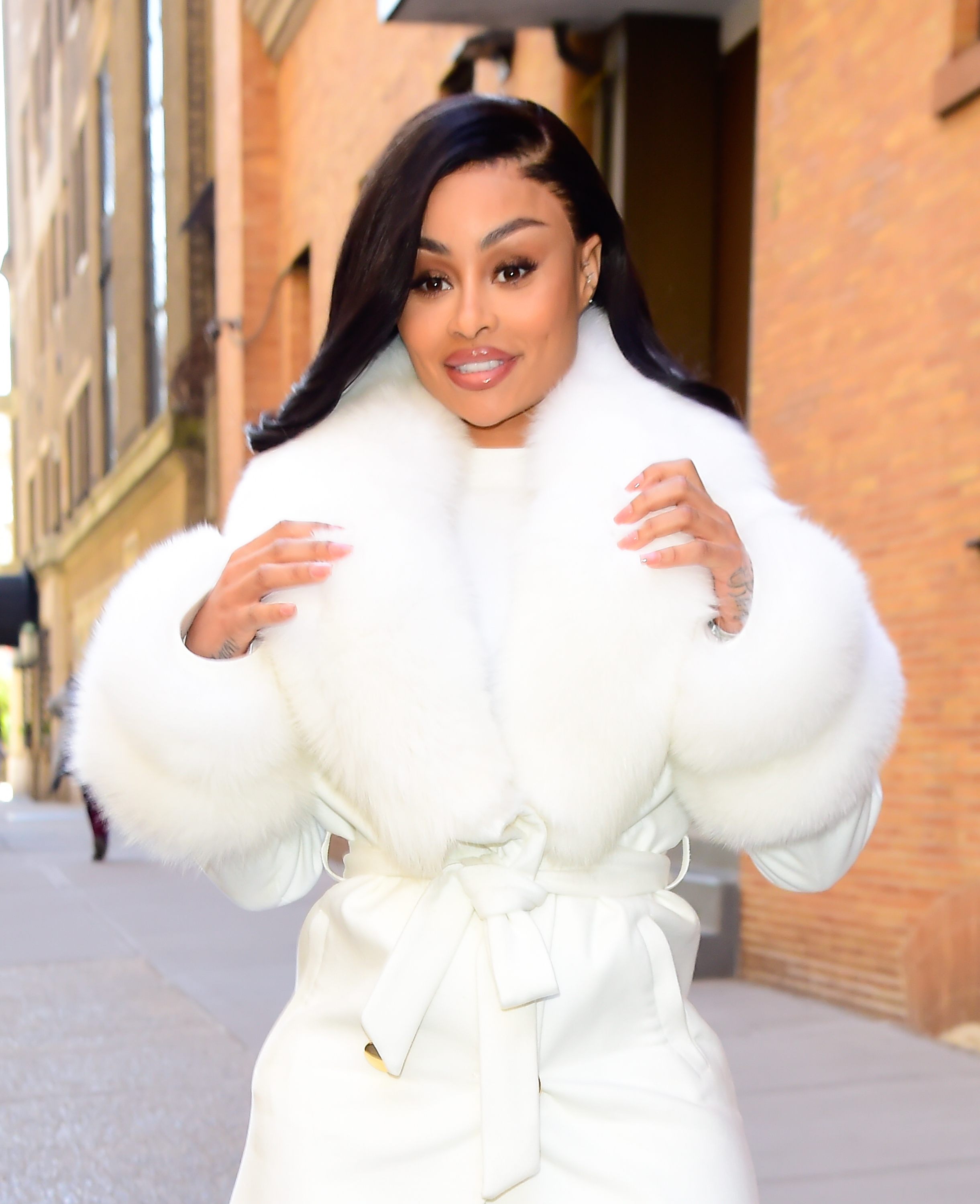 Close-up of Blac Chyna in a white fur-collar coat