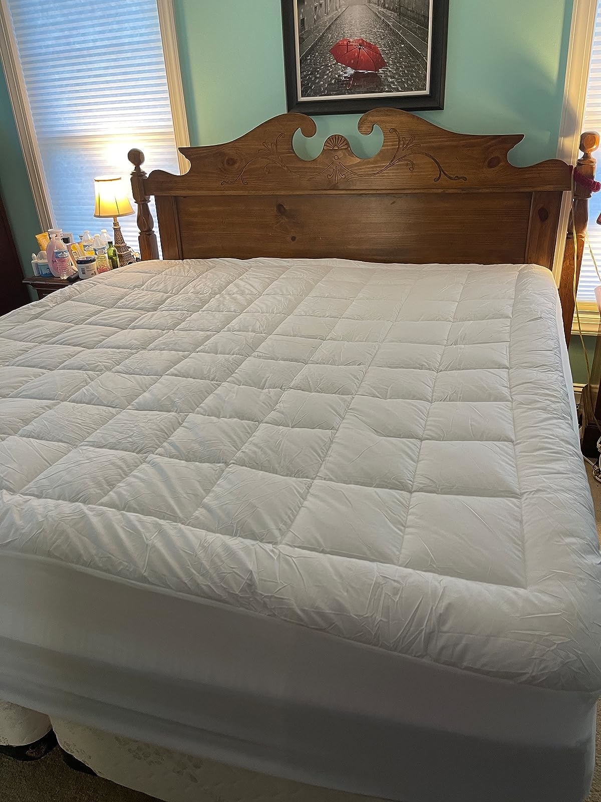 Reviewer&#x27;s photo of the mattress topper on a bed