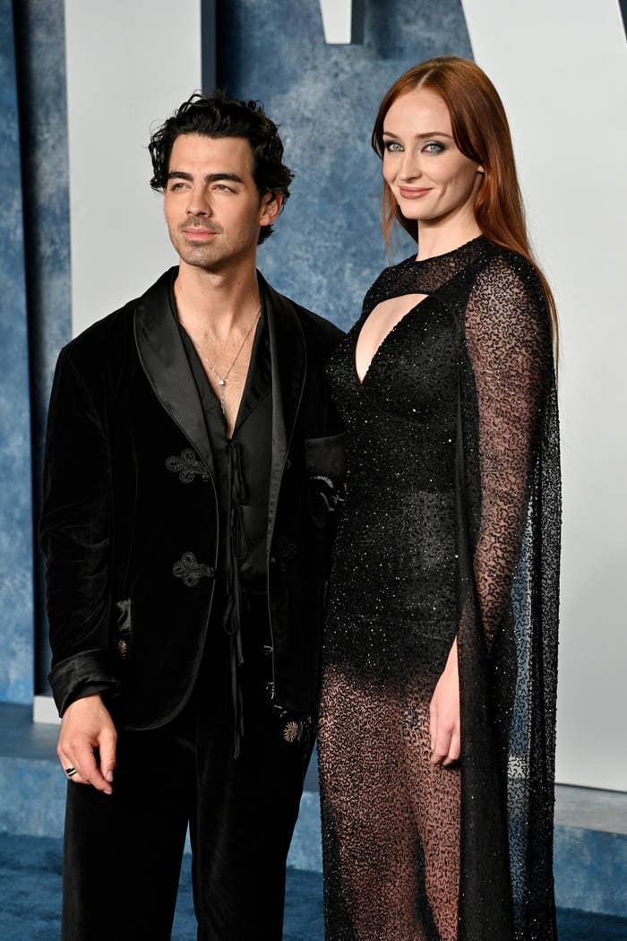 Sophie Turner and Joe Jonas stand on the red carpet as photographers snap their pictures