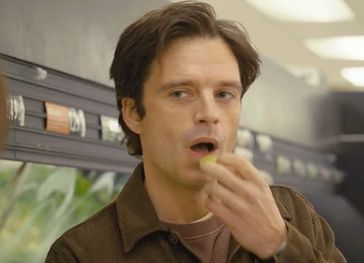 Closeup of Sebastian Stan eating a grape