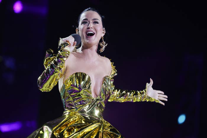 Katy Perry singing on stage in a metallic outfit