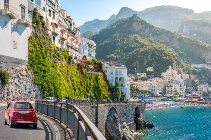 a car driving along the amalfi coast in italy