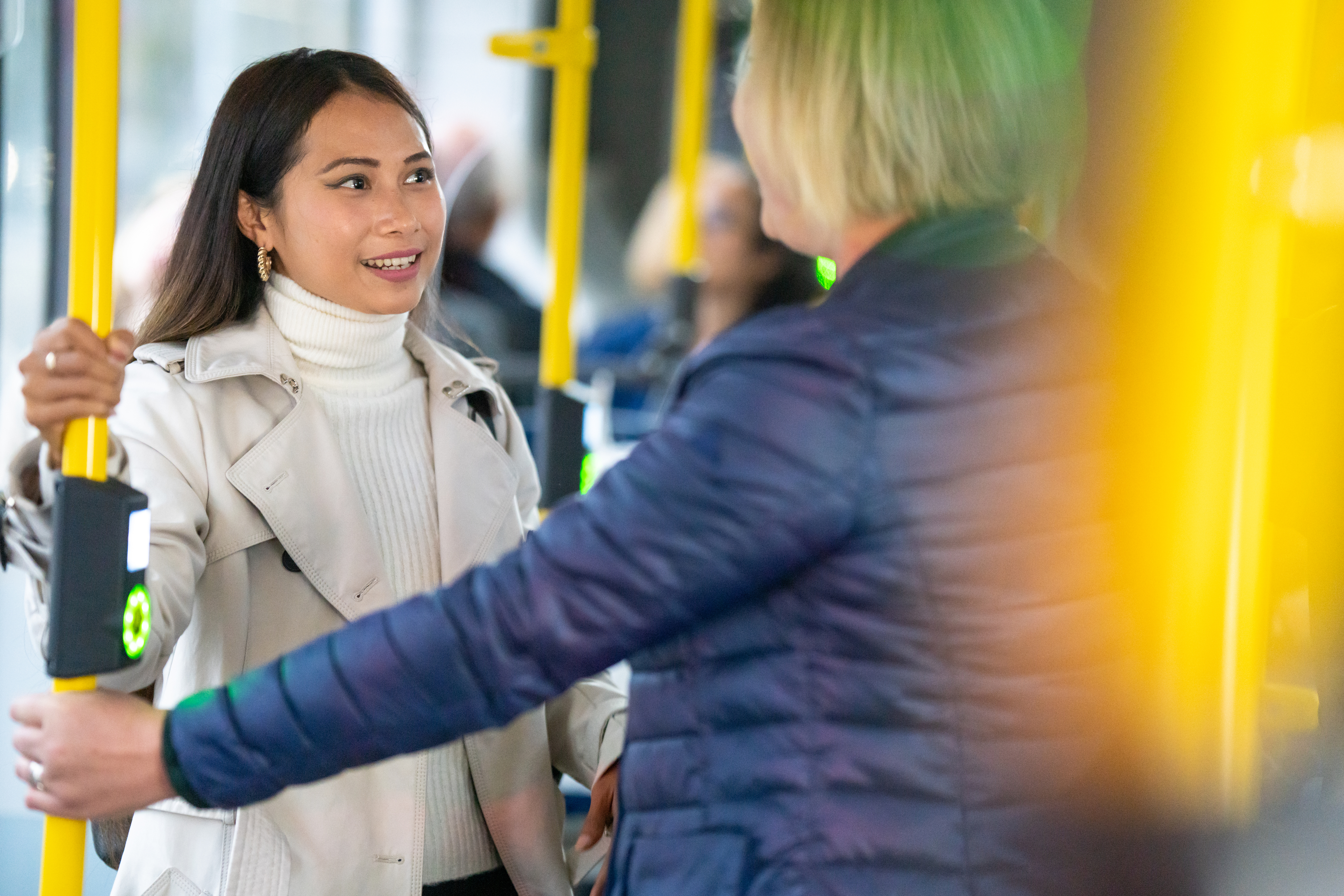 two women talking on a bus