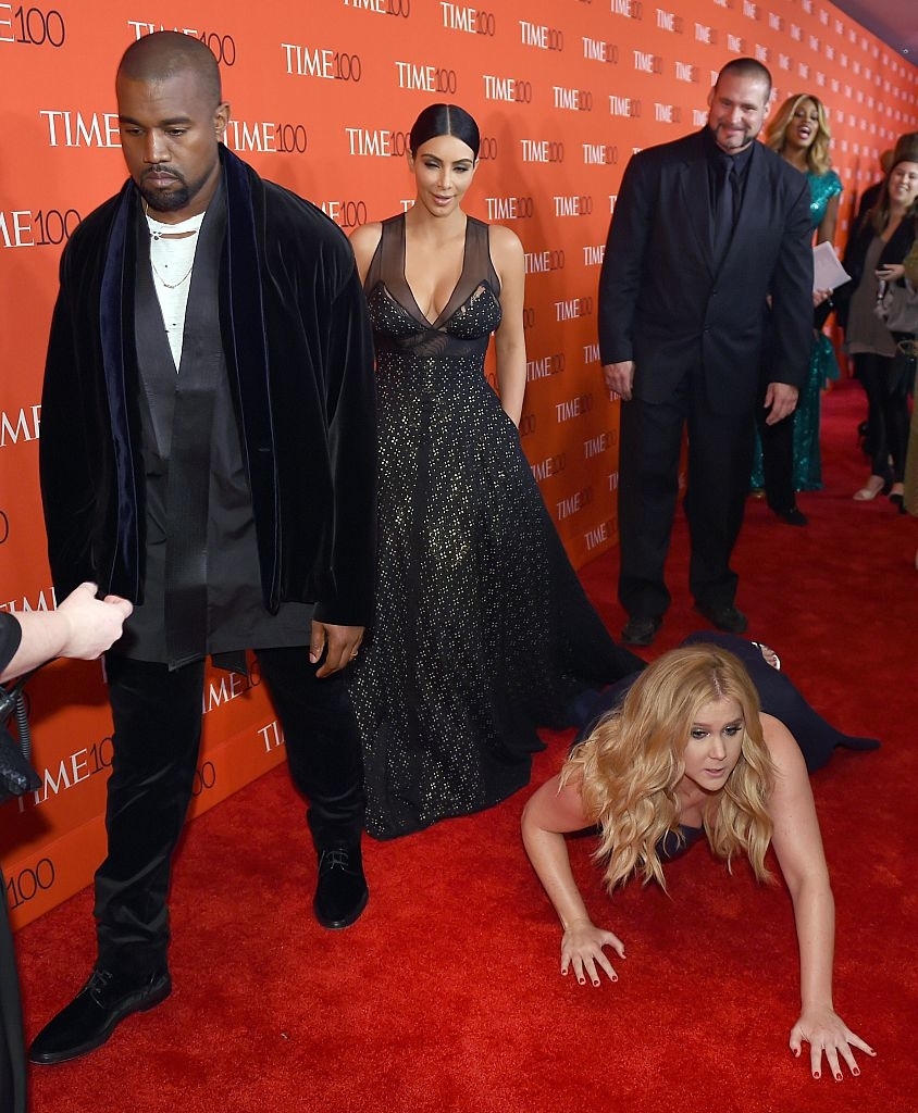 kim and kanye walking past amy who is on the ground
