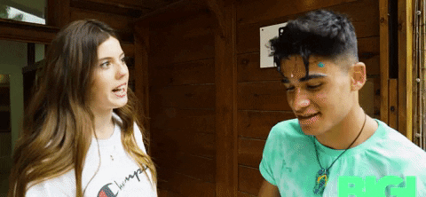 a girl throwing a raw egg in a boy&#x27;s face