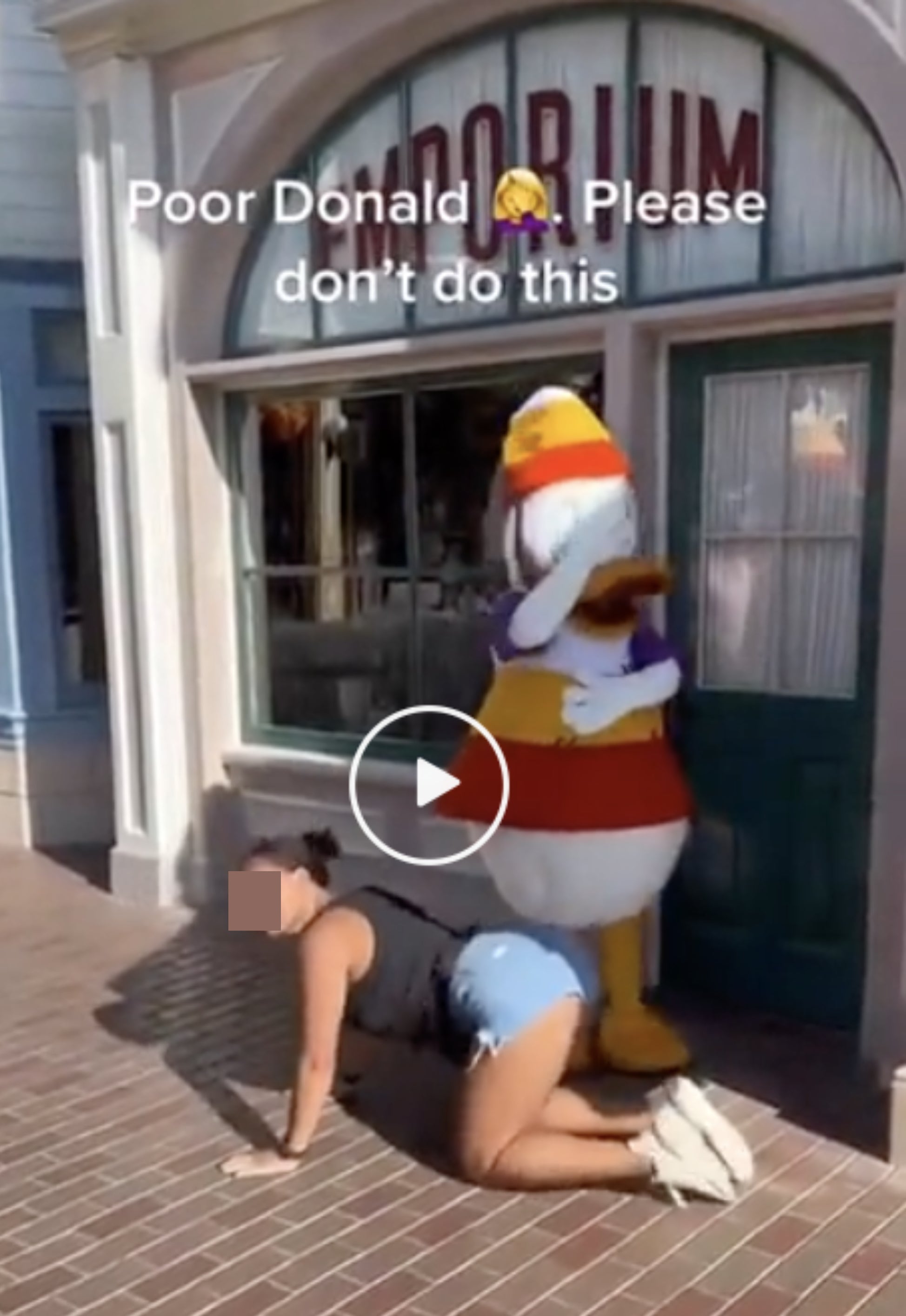 A woman twerking on Donald Duck at an amusement park