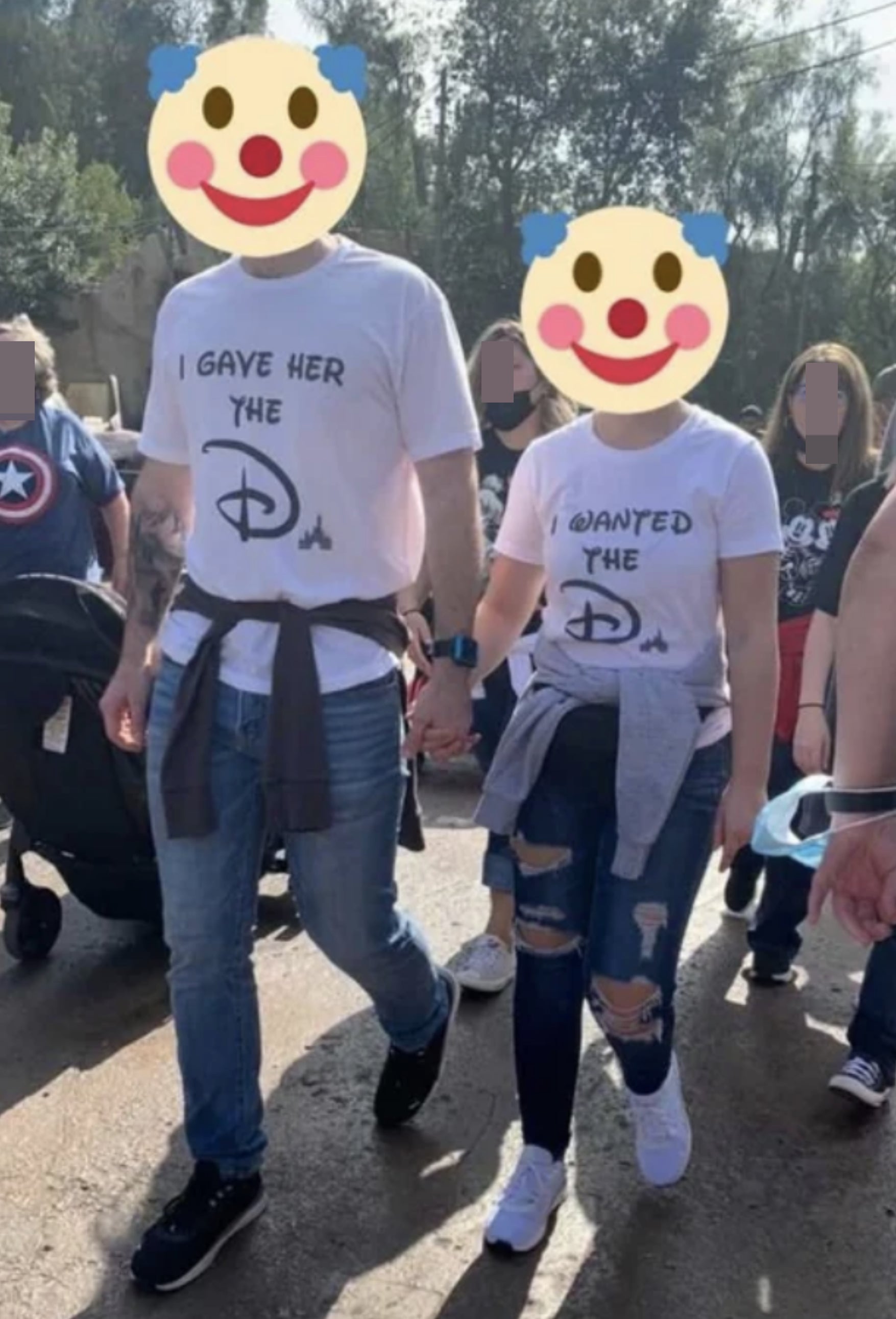 A couple wearing T-shirts, with the man's shirt saying "I gave her the D" and the woman's shirt saying "I wanted the D," with both D's written in the Disney style