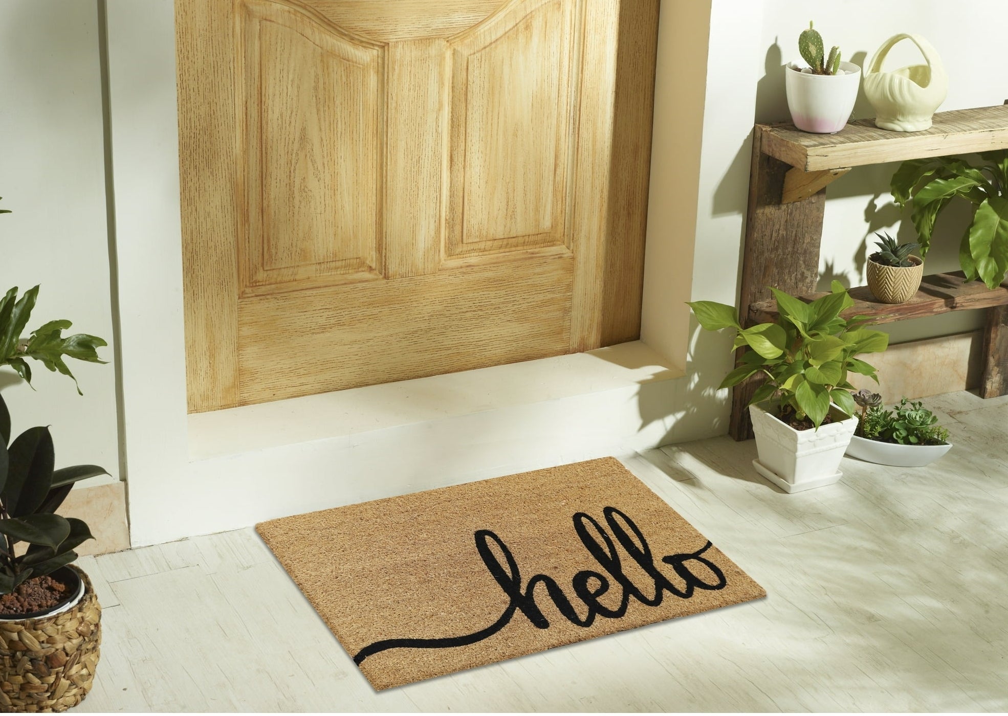brown door mat that says "hello" on the front