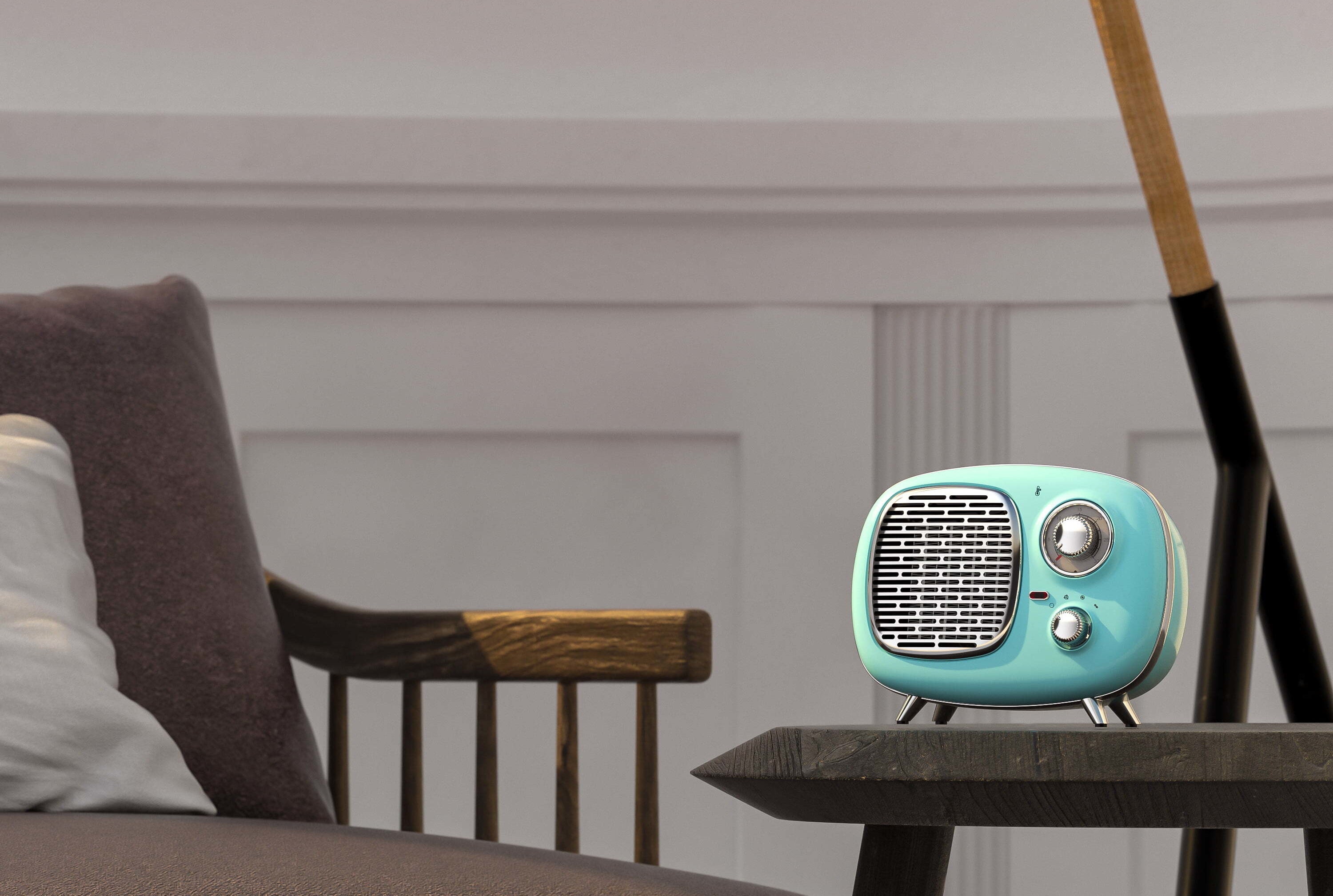 The heater, which resembles a retro radio, with a rounded body, metallic knobs and grill, and four legs, in mint green