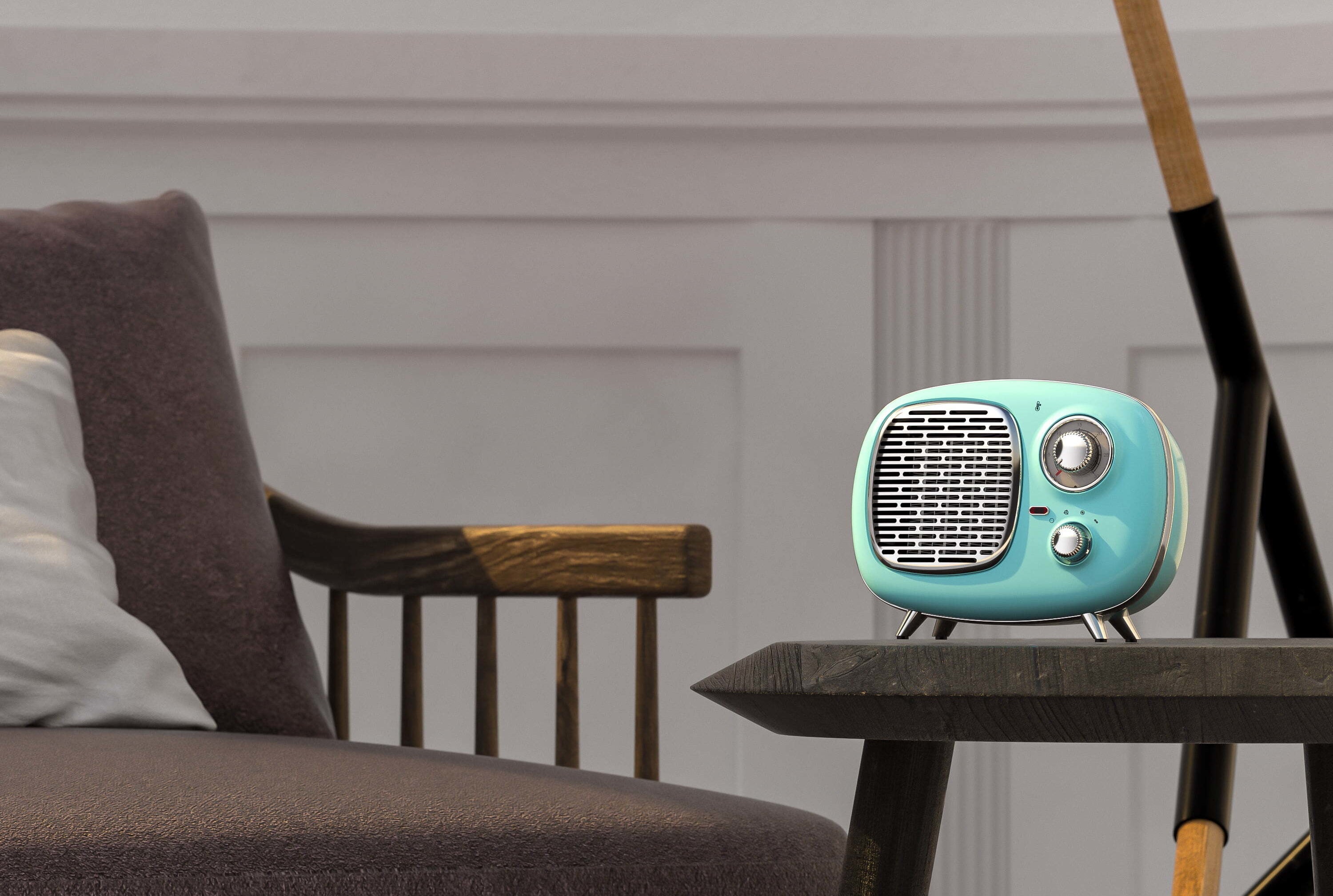 The heater, which resembles a retro radio, with a rounded body, metallic knobs and grill, and four legs, in mint green