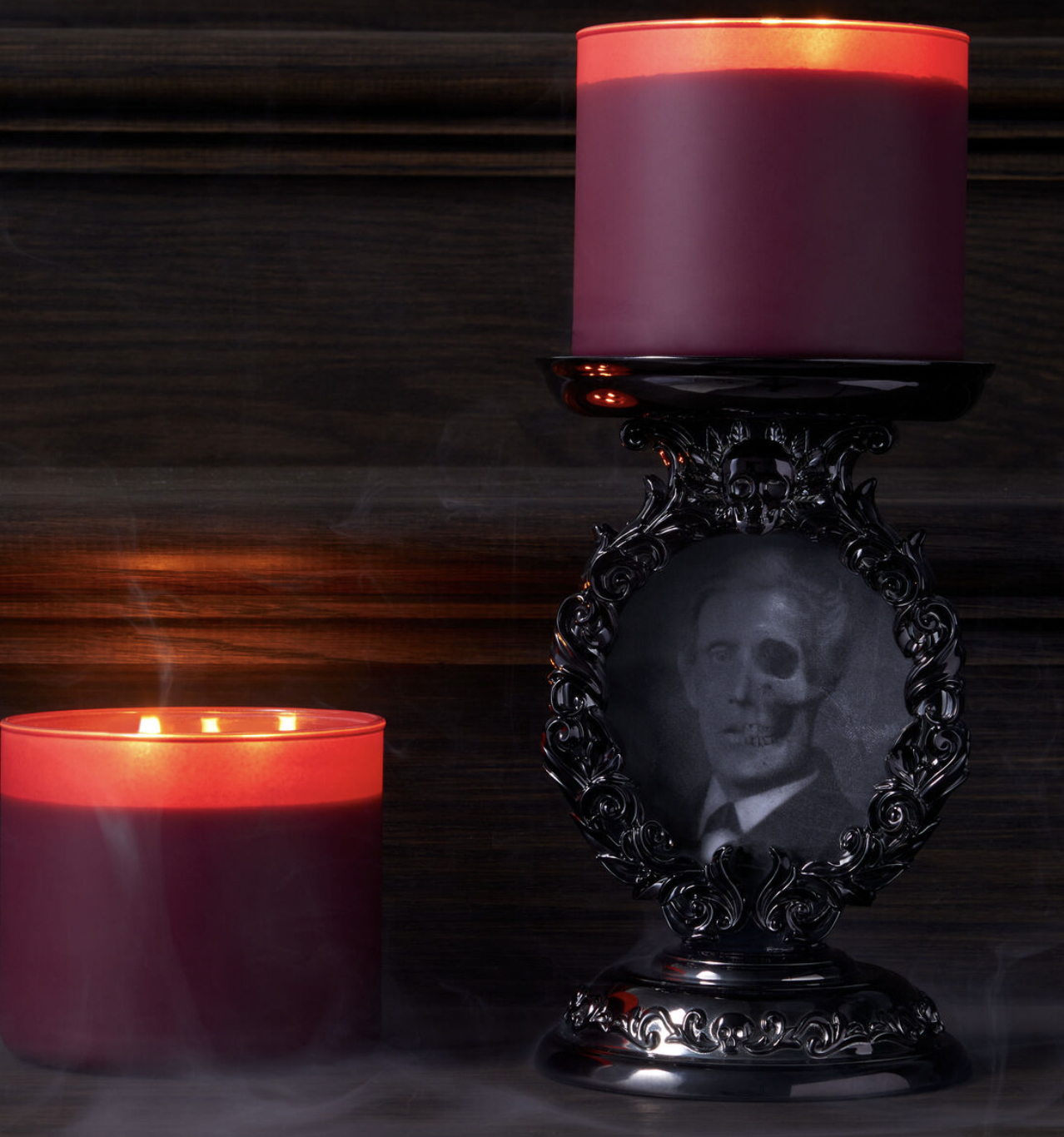the candle pedestal with a spooky picture in it