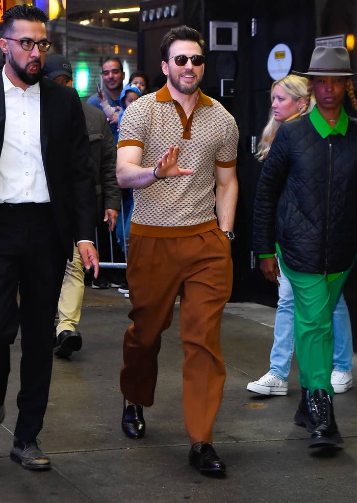 Chris Evans walking and waving to fans at an event