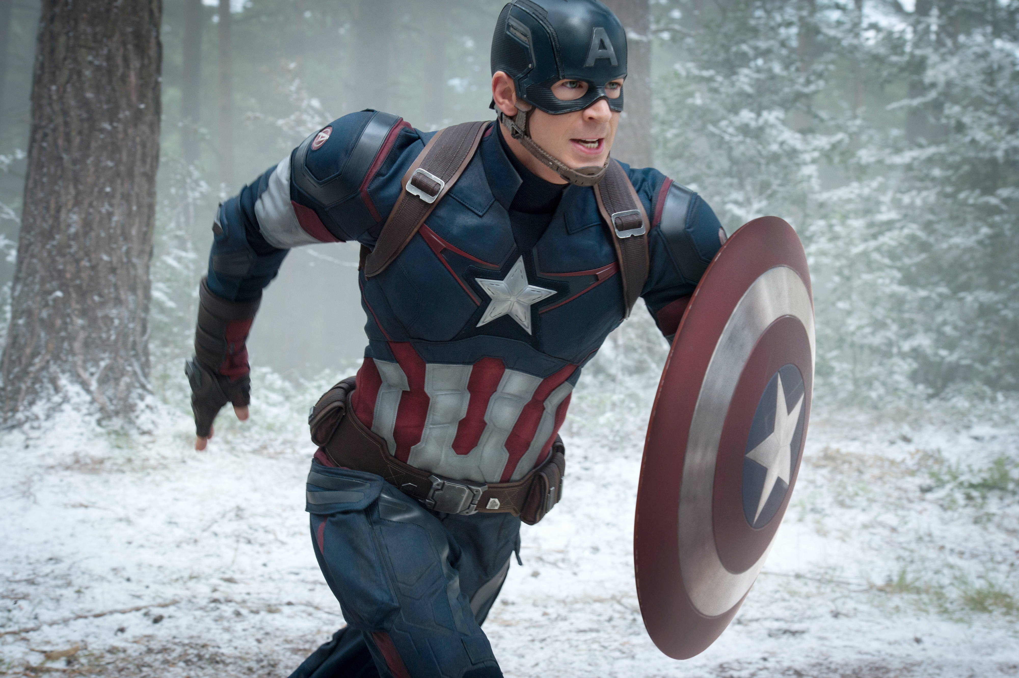 Closeup of Chris as Captain America running through a snowy forest
