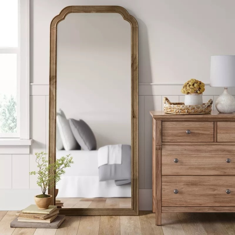 the oversized mirror leaning against a wall
