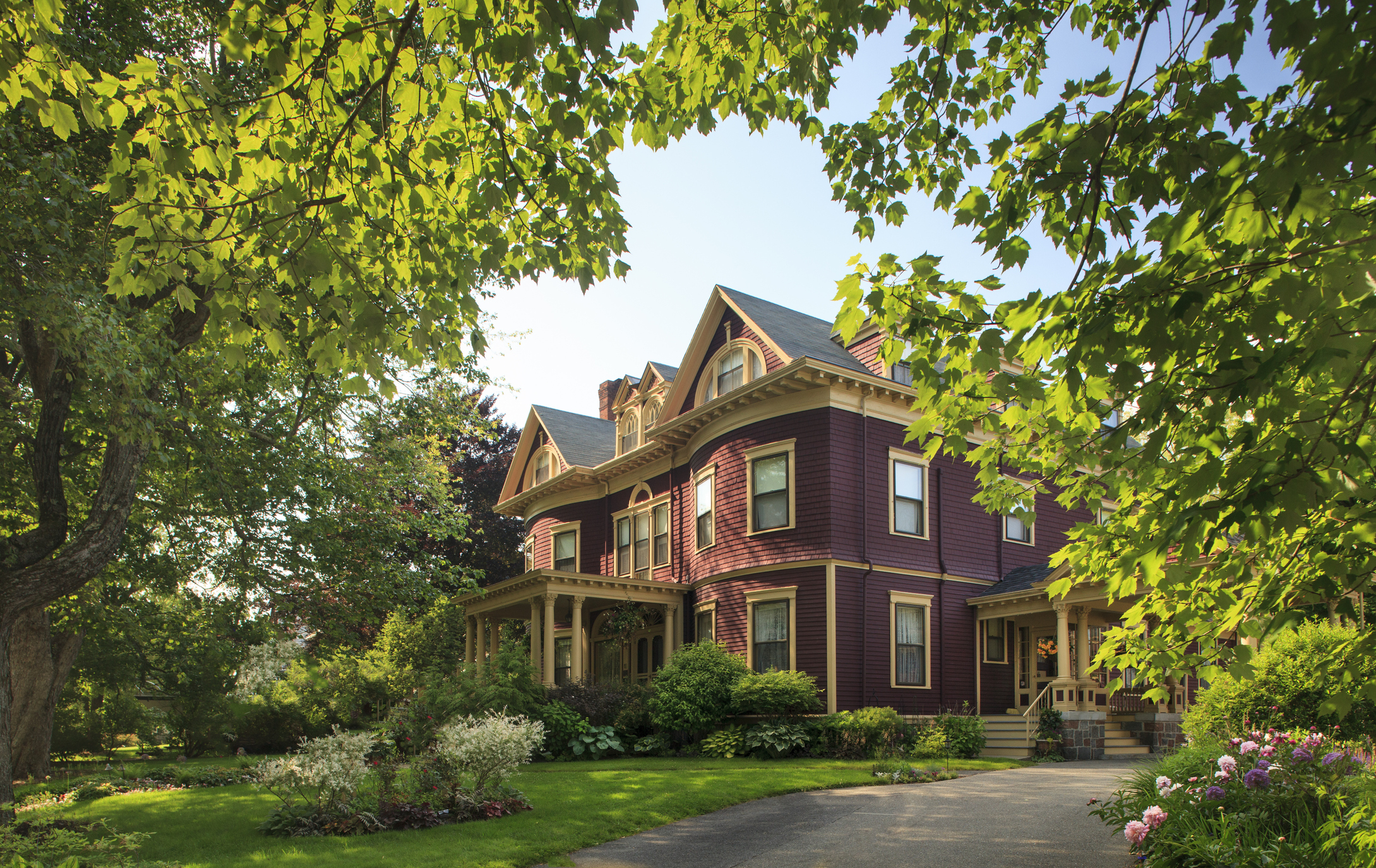 Victorian mansion surrounded by a lush garden