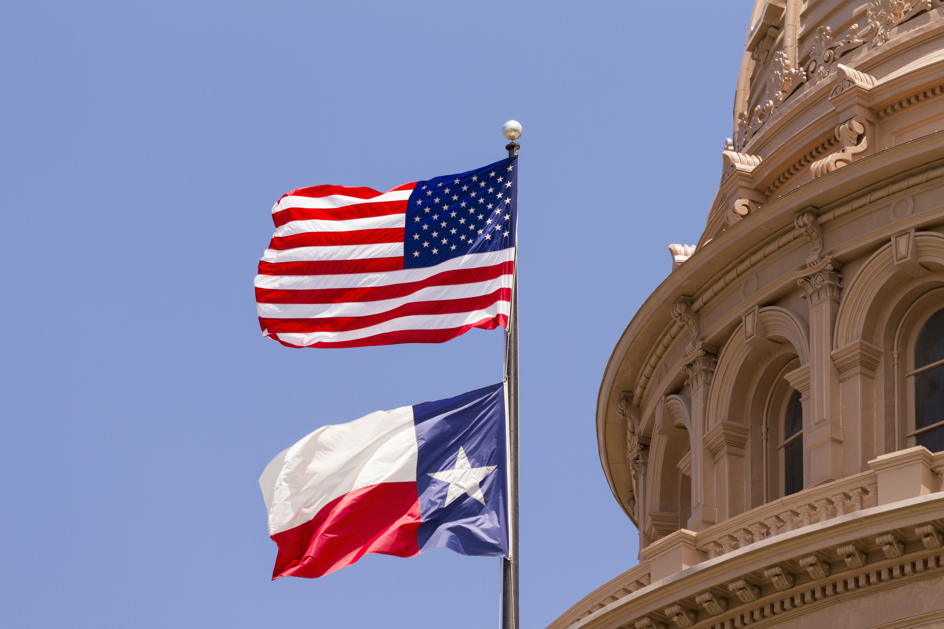 An American and Texan flag in Austin