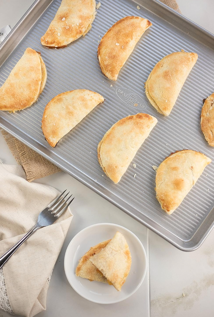 crescent shaped pastries on a corrugated silver tray