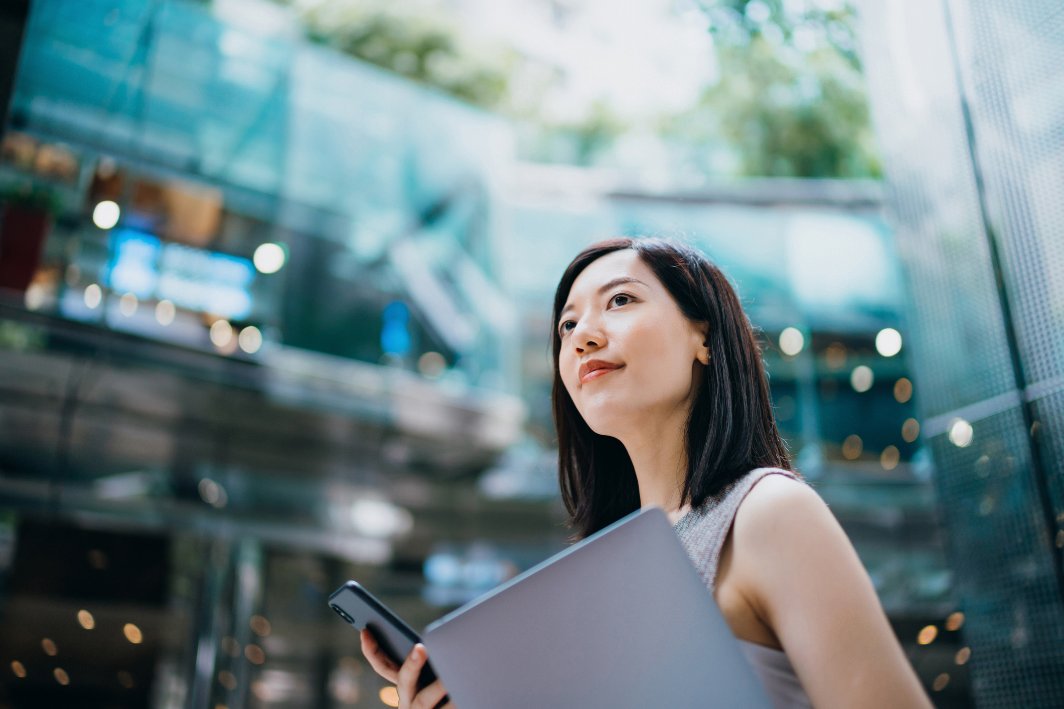 Young businesswoman carrying smartphone