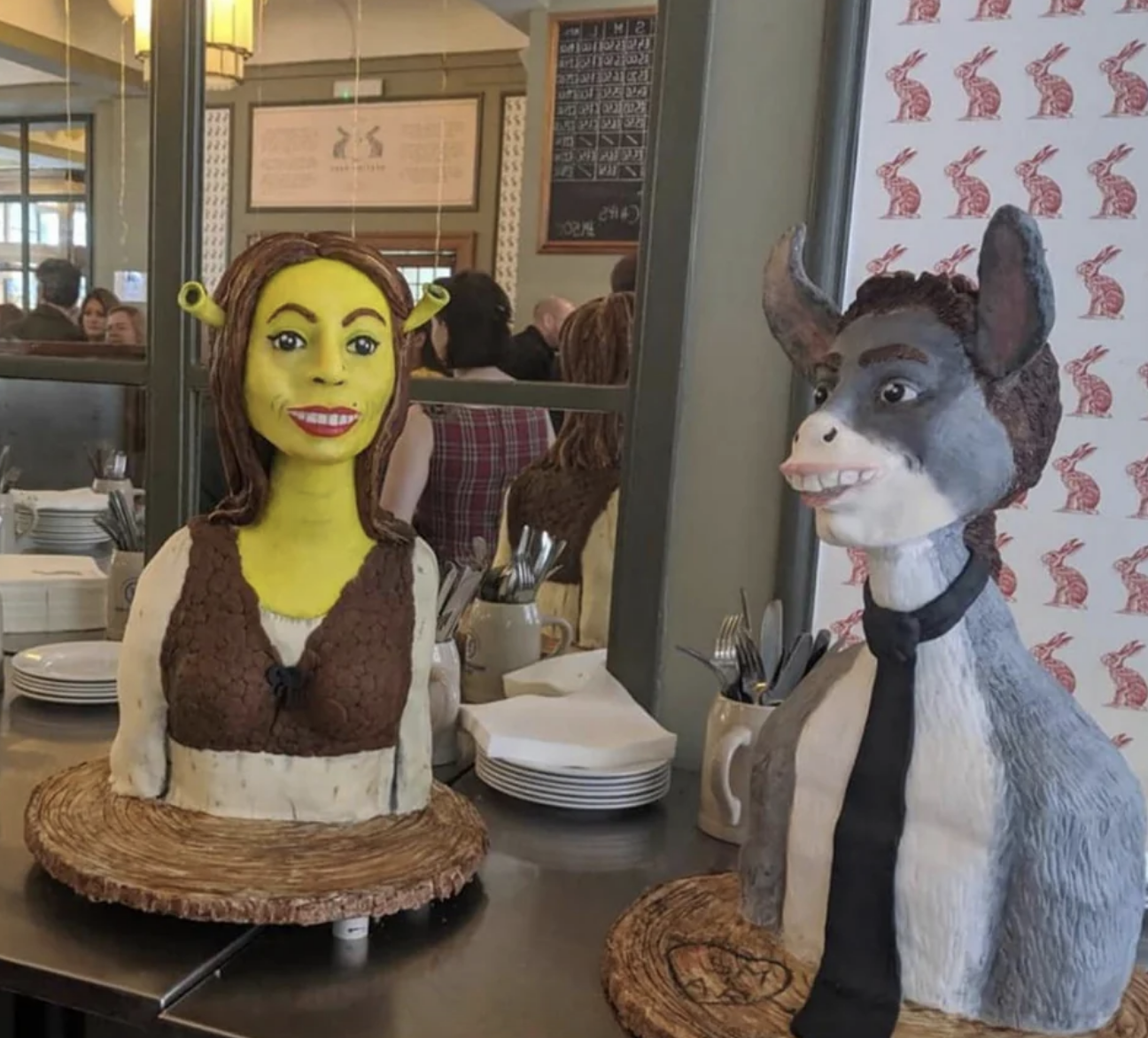 There are two cakes, one intended to look like Fiona from Shrek, the other like Donkey from Shrek; neither actually look like the characters