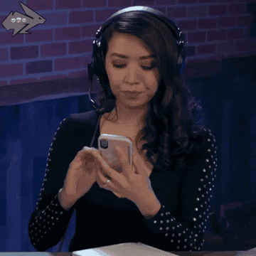 A woman looking panicked at something she's seeing on her phone
