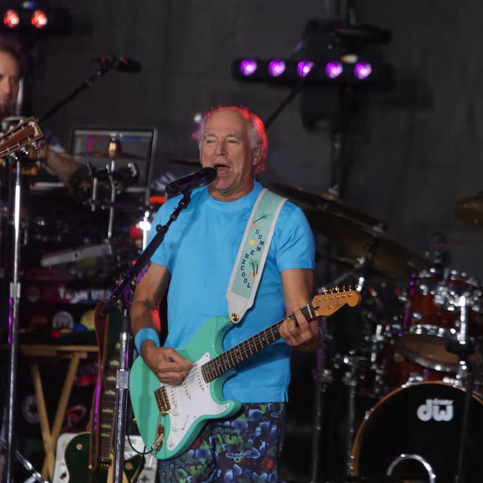 Jimmy Buffet playing guitar on stage