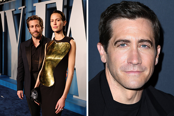 Jake Gyllenhaal poses for a photo with an arm behind Jeanne Cadieu vs Jake Gyllenhaal smirks as he has his photo taken