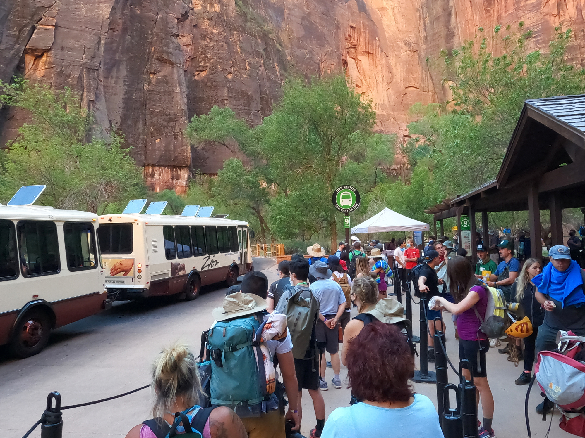 people waiting for a shuttle outside the park