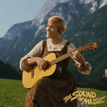 Julie Andrews plays a guitar amidst mountains. Text reads &quot;The Sound of Music.&quot;