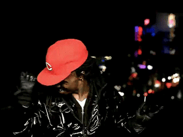 Lil Wayne rapping with a lollipop.