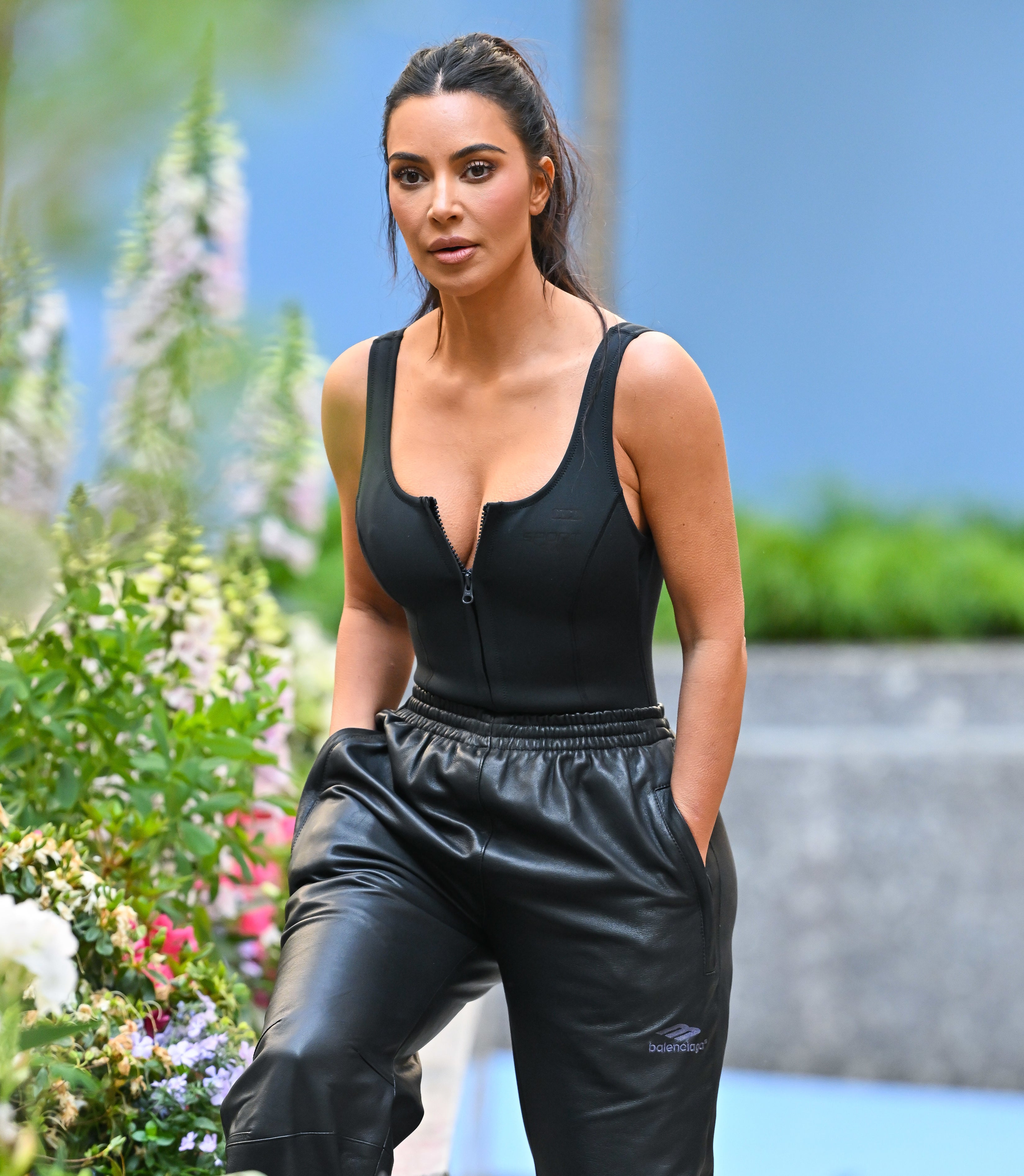 kim walking outside wearing leather pants