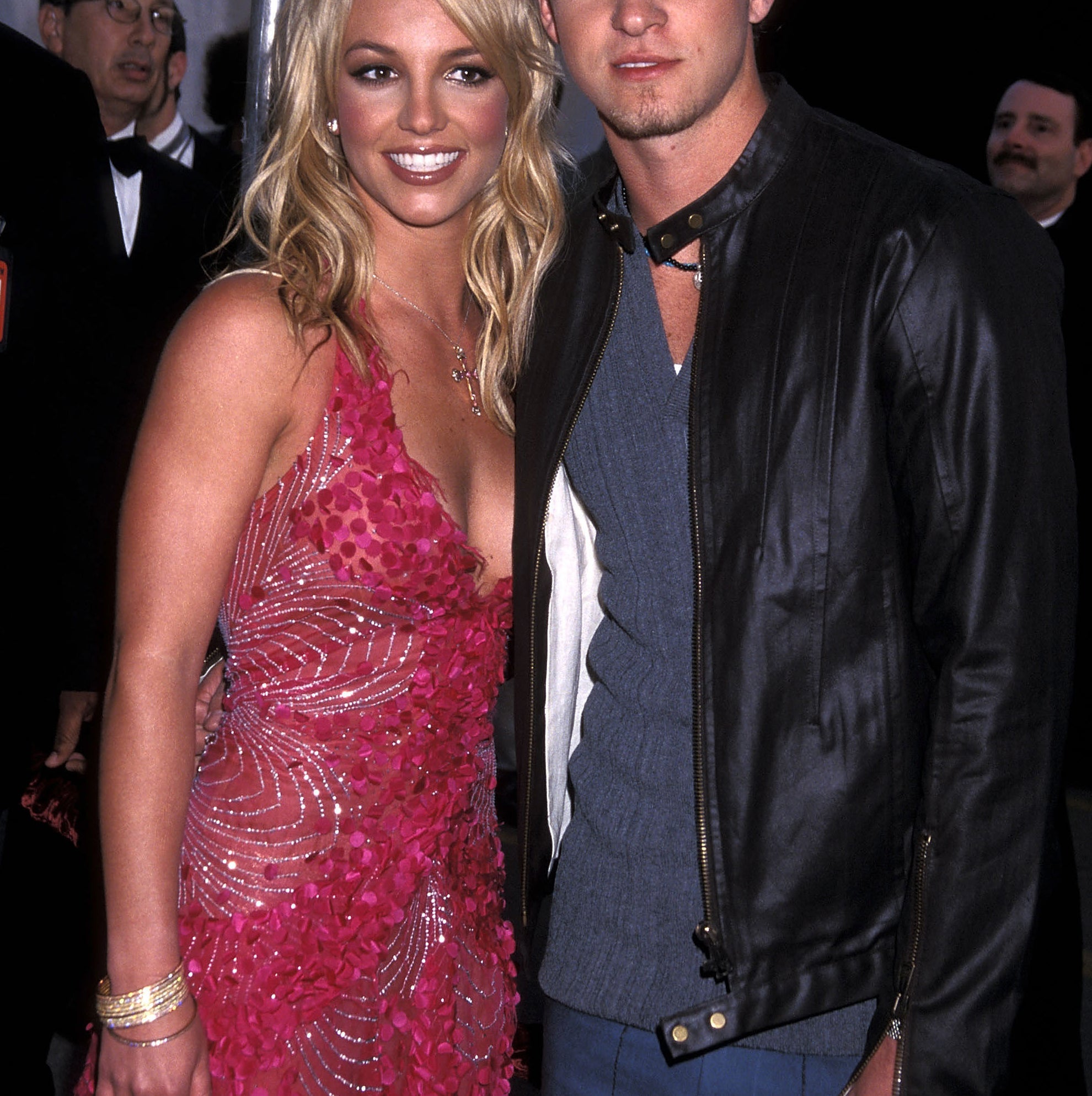 Justin Timberlake and Britney Spears smiling for photographers at an event