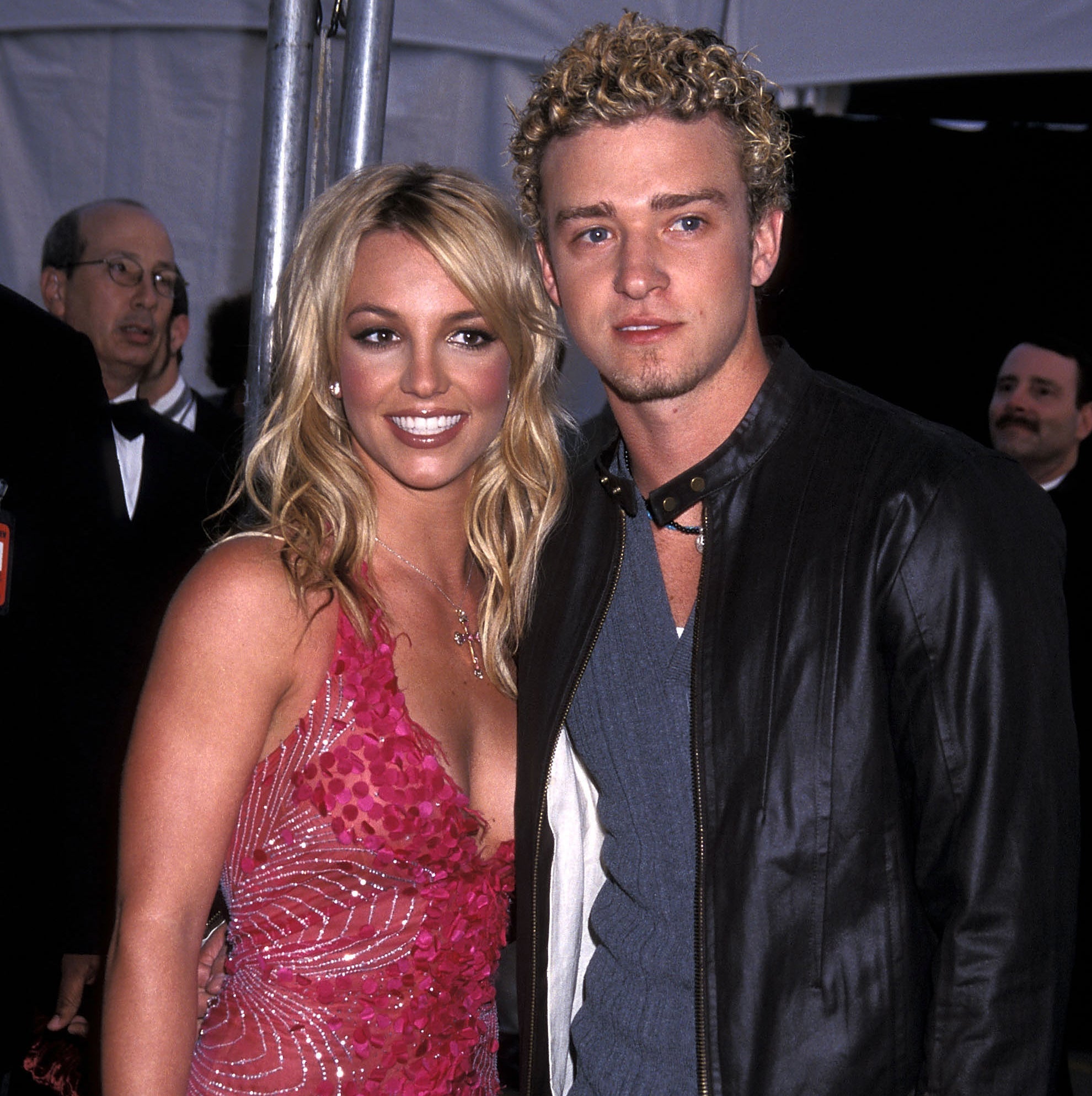 Justin Timberlake and Britney Spears smiling for photographers at an event
